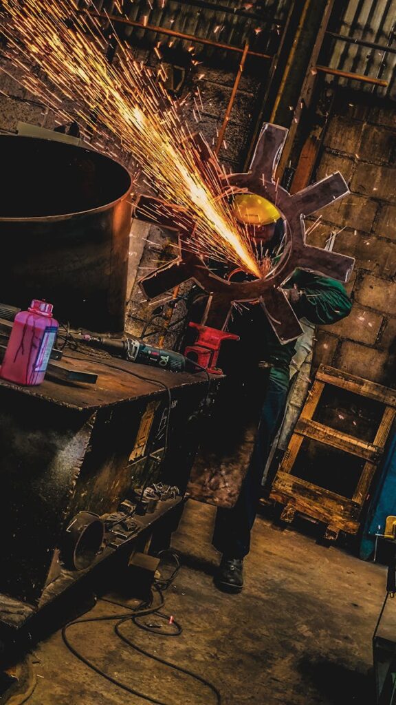 The Art of Drawing Readers In: Your attractive post title goes here A welder uses a grinder in a dimly lit factory, creating a spectacular shower of sparks.